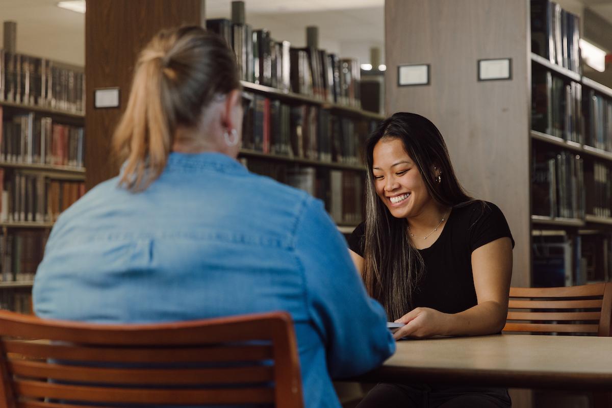 student meeting with older person and having a conversation.